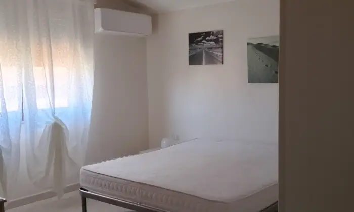 Rexer-Carbonia-Appartamento-luminoso-CameraDaLetto